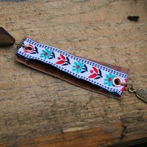 leonie. a leather and floral trim necklace